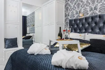 a hotel room with two beds and a table at Golden Fish - New Apartment - Old Town in Kraków