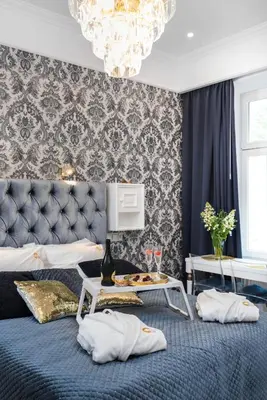 a bedroom with a bed and a chandelier at Golden Fish - New Apartment - Old Town in Kraków