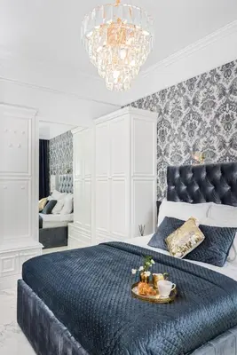 a bedroom with a king sized bed with a tray of food on it at Golden Fish - New Apartment - Old Town in Kraków