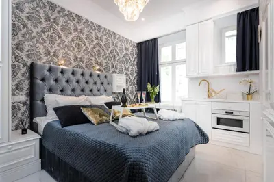 a bedroom with a large bed with a black headboard at Golden Fish - New Apartment - Old Town in Kraków