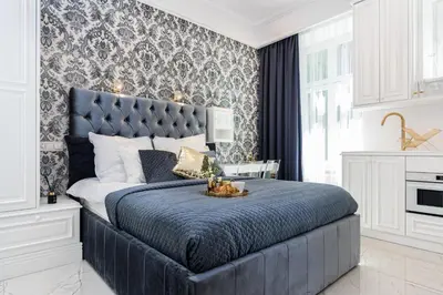 a bedroom with a large bed with a blue headboard at Golden Fish - New Apartment - Old Town in Kraków
