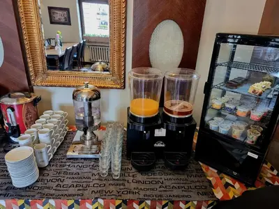 a table with a blender and cups and a mirror at Rainbow Apartments 1 Premium in Kraków