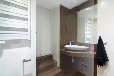 a bathroom with a sink and a mirror at Rainbow Apartments 1 Premium in Kraków