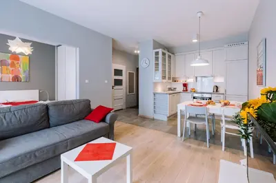 a kitchen with a counter with a microwave and a table at ApartmentPrestige Central Station in Kraków
