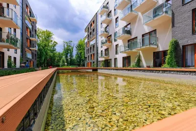 a park in a city with tall buildings at ApartmentPrestige Central Station in Kraków