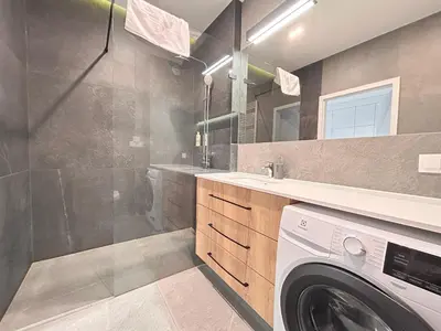 a washing machine in a bathroom with a washer at ApartmentPrestige Central Station in Kraków