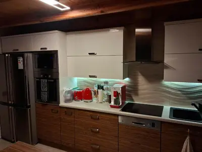 a red coffee machine with a cup of coffee at Beskid House Kurów in Kurów