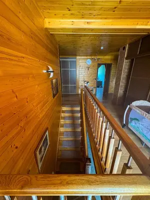 a bedroom with a bed in a wooden attic at Beskid House Kurów in Kurów