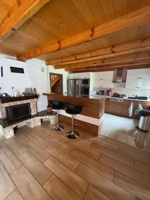 a kitchen with a counter and stools in a room at Beskid House Kurów in Kurów