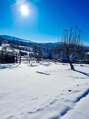 a gazebo in the snow in a town at Beskid House Kurów in Kurów