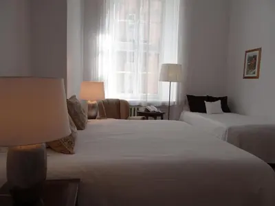 a hotel room with two beds and a window at Boutique Aparthotel in Kraków