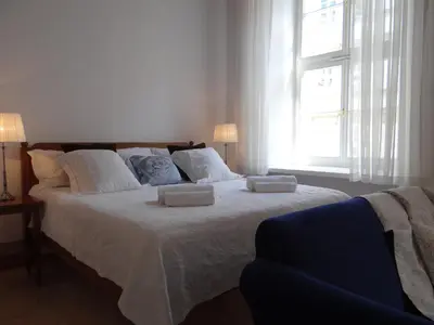a bedroom with a large bed with two pillows on it at Boutique Aparthotel in Kraków