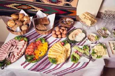 a table topped with lots of different types of food at Boutique Aparthotel in Kraków