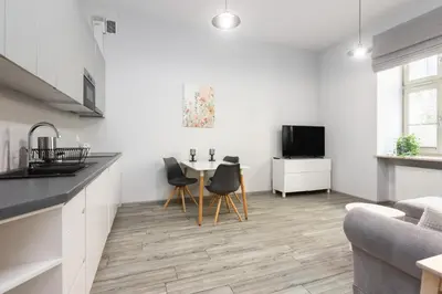a kitchen and living room with a table and chairs at Luxury Apartments Old Town Topolowa in Kraków