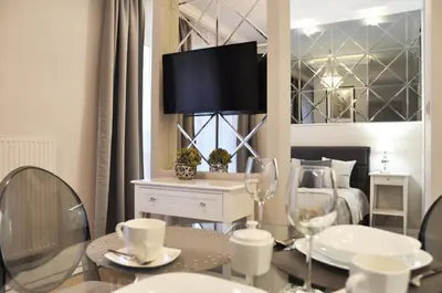 a room with a bed and a table with wine glasses at Rakowicka 22H - studio by Homeprime in Kraków