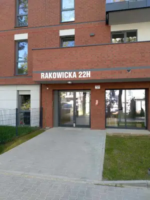 a brick building with a sign on the front of it at Rakowicka 22H - studio by Homeprime in Kraków