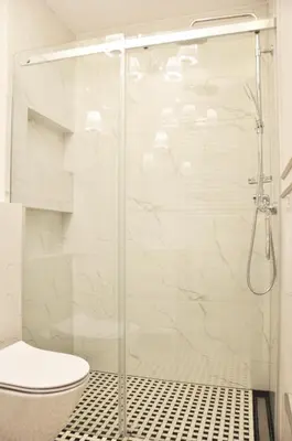 a bathroom with a glass shower with a toilet at Rakowicka 22H - studio by Homeprime in Kraków