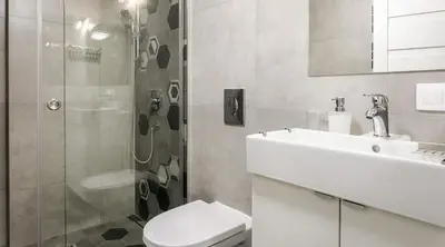 a bathroom with a toilet and a sink and a shower at Miodowe mieszkanko in Kraków