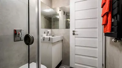 a white bathroom with a sink and a shower at Miodowe mieszkanko in Kraków