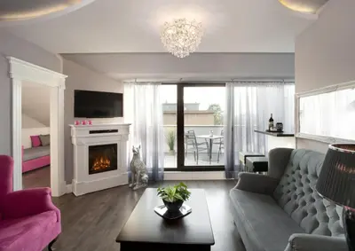a living room with a couch and a fireplace at Parkside Apartments Old Town in Kraków