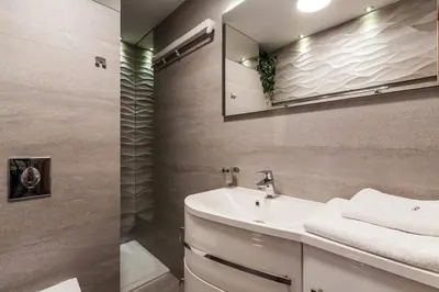a bathroom with a sink and a mirror at Parkside Apartments Old Town in Kraków