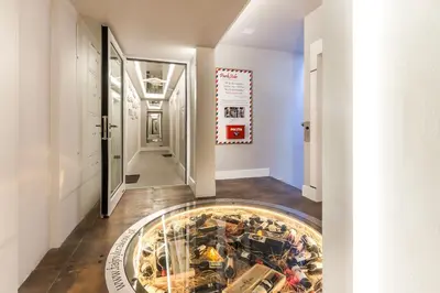 a hallway with a display of toy cars on a floor at Parkside Apartments Old Town in Kraków