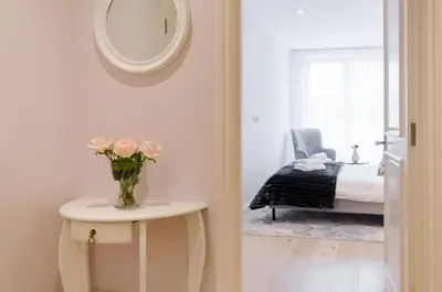 a room with a vase of flowers on a table and a bed at Old Town Premium Kazimierz Apartments in Kraków