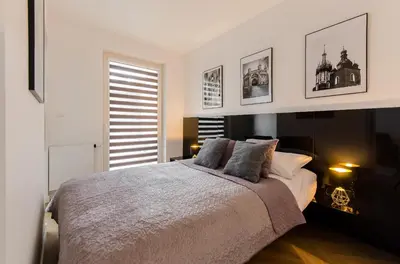 a bedroom with a large bed with two pillows at Old Town Premium Kazimierz Apartments in Kraków