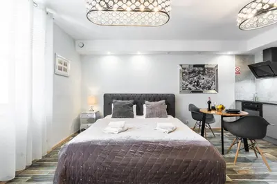 a bedroom with a large bed and a table at Old Town Premium Kazimierz Apartments in Kraków