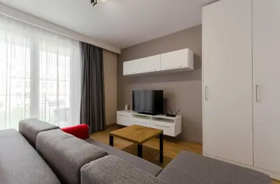 a living room with a couch and a tv at Old Town Premium Kazimierz Apartments in Kraków