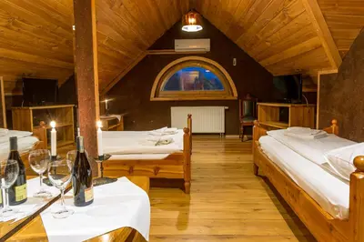 a room with two beds and a table with wine glasses at Krakowiacy i Górale in Krzyszkowice