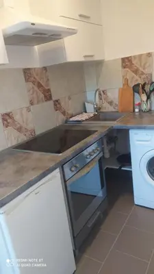 a kitchen with a sink and a stove top oven at Gdow Riverside Apartments and Tours in Gdów
