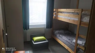 a room with a bunk bed and a window at Gdow Riverside Apartments and Tours in Gdów