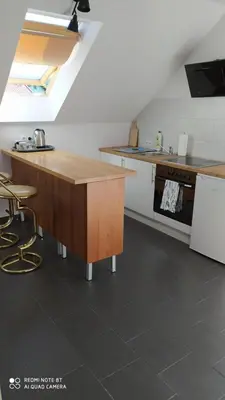 a kitchen with a wooden counter and a sink at Gdow Riverside Apartments and Tours in Gdów