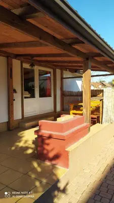 an outdoor patio with a wooden roof and stairs at Gdow Riverside Apartments and Tours in Gdów