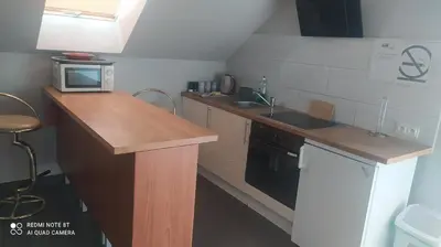 a kitchen with a counter and a sink and a microwave at Gdow Riverside Apartments and Tours in Gdów