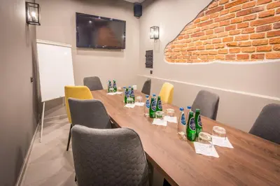 a conference room with a long wooden table and chairs at Hotel Lavender in Kraków