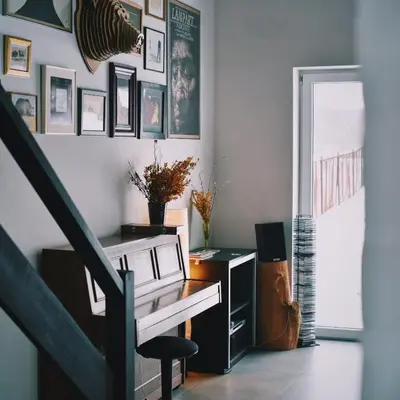 a living room with a staircase and a chair at Pradnik Valley Lodge in Prądnik Korzkiewski