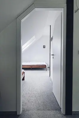 a door leading to a bedroom with a bed at Pradnik Valley Lodge in Prądnik Korzkiewski