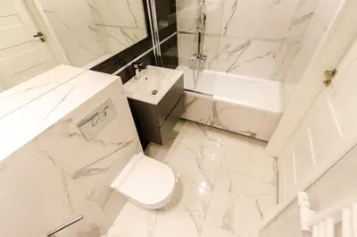 a white bathroom with a toilet and a sink at Old Town Premium Queen`s Apartments in Kraków