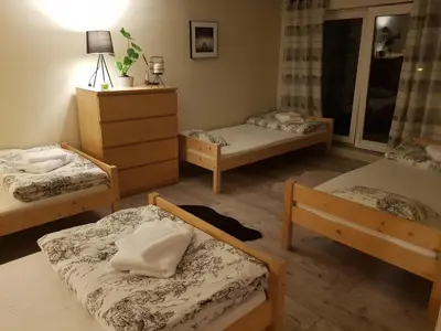 a room with four beds and a dresser at Noclegi Jaworzno in Jaworzno
