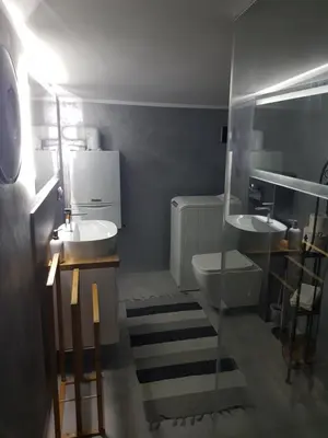 a bathroom with two sinks and a toilet at Noclegi Jaworzno in Jaworzno