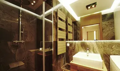 a bathroom with a sink and a shower at Pawia Apartments Modern in Kraków
