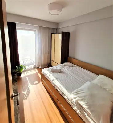 a bedroom with a large bed with a window at Pawia Apartments Modern in Kraków