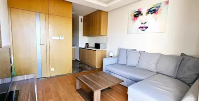 a living room with a couch and a table at Pawia Apartments Modern in Kraków