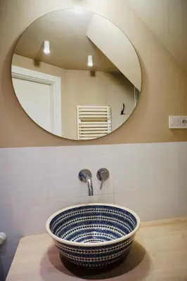 a bathroom with a sink with a mirror at lux Floriańska in Kraków