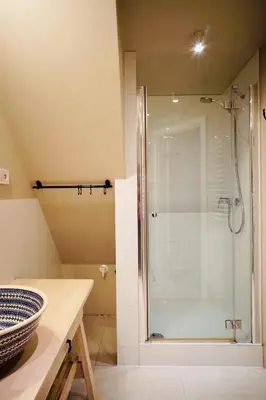 a bathroom with a shower with a glass door at lux Floriańska in Kraków