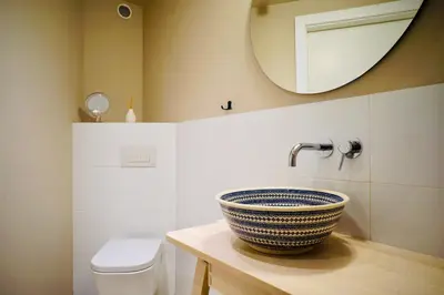 a bathroom with a sink and a mirror and a toilet at lux Floriańska in Kraków