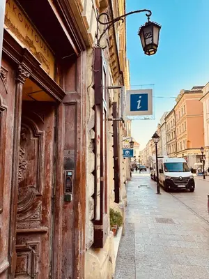 a street sign on the side of a building at lux Floriańska in Kraków