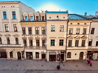 a group of buildings on a city street at lux Floriańska in Kraków